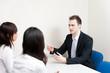 © taka - a young businessman talking to women