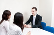 © taka - a young businessman talking to women