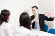 © taka - a young businessman talking to women