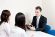 © taka - a young businessman talking to women