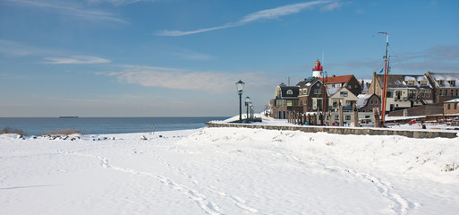 Old dutch fishery village seen in wintertime from the beach