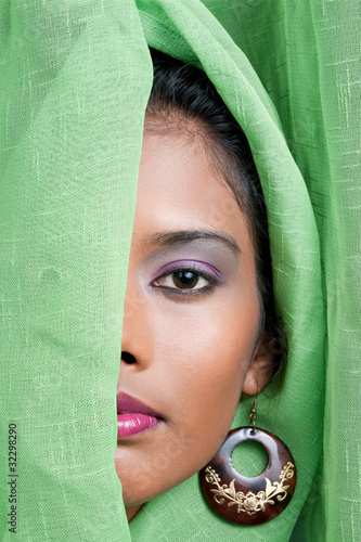 Beautiful Indian Woman Looks From Behind A Green Curtain Buy