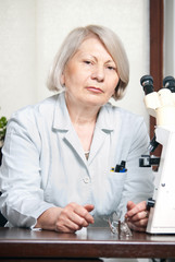 Poster - Female doctor looking in office with microscope