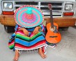© lunamarina - Man wearing sombrero and poncho resting in front of a truck