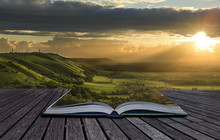 Magical Book With Contents Spilling Into Landscape Background