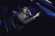 © konradbak - Elegant man driving and talking over cellphone