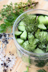 Sticker - cucumbers in the jar with dill salt and pepper on the table