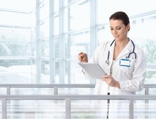 Female Doctor Using Tablet In Hospital