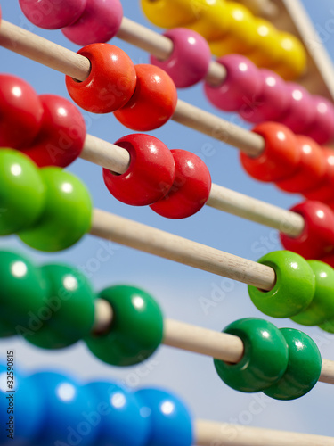 Nowoczesny obraz na płótnie Close-up of a coloured children abacus in front of blue sky