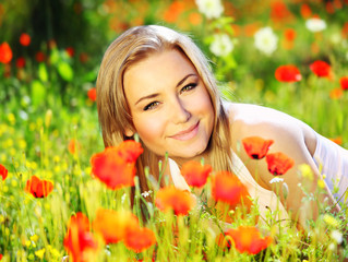 Wall Mural - Beautiful female laying on the flower filed