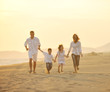 © .shock - happy young family have fun on beach at sunset