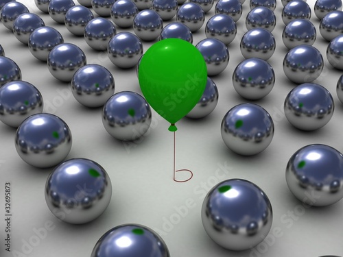 Green balloon among the shiny metallic balls