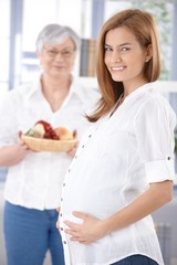 Canvas Print - Attractive expectant mother smiling happily