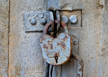 Rusty Padlock On An Old Metal Door
