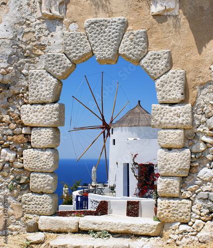 Naklejka na meble Windmill through an old Venetian window, Greece