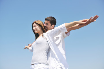 happy young couple have fun on beach