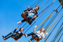 Teenage Girls On The Chain Swing Carousel