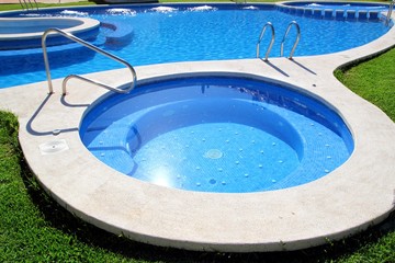 blue jet spa pool in green grass garden