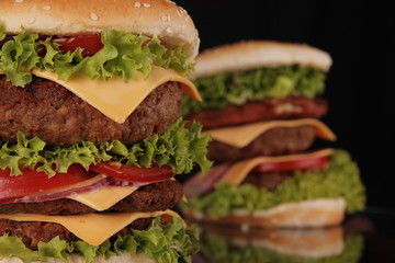 Wall Mural - delicious hamburgers on black background