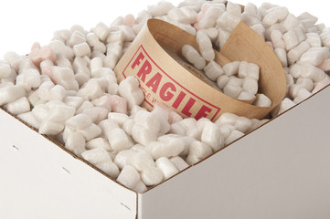 box of packing peanuts with roll of fragile tape inside