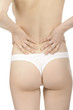 © Nobilior - Woman massaging pain back isolated over a white background.