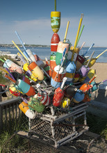 Colorful Buoys Stacked Together On Top Of A Lobster Trap