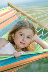 Wall Mural - Little girl in colorful hammock