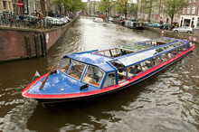 Motor Boat In Amsterdam Channel, Netherlands