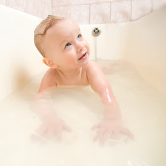 Wall Mural - Adorable baby taking bath and swim on chest