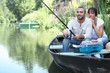 © auremar - Couple fishing in a small boat on a river
