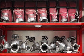 Fire cocks and hoses accurate organized inside fire engine