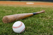 Baseball And Bat On Field