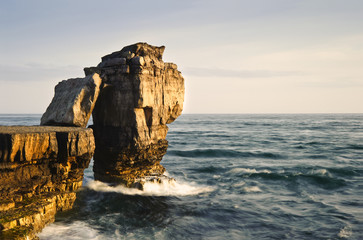 Wall Mural - stunning geological rock cliff formations with waves crashing in