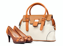 Pair Of Female Shoes And Handbag Over White Background
