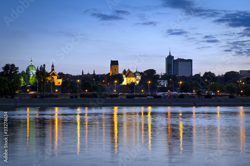 Board z aluminiowym obramowaniem Warszawa durung sundown z odbiciem w rzece Wisły