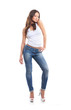 © Acronym - A young and sexy brunette Caucasian woman in stylish jeans