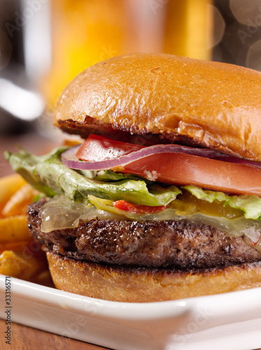 Board z aluminiowym obramowaniem Smakosz cheeseburger z kuflem piwa w tle