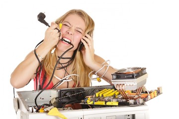 blond woman repairing computer biting power cable