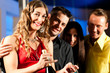 © Kzenon - Leute mit Drinks in Bar oder Club