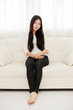 © taka - beautiful asian woman relaxing on the couch