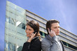 © auremar - Montage of business couple in front of a modern building