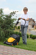 © Denizo - Teen boy mows the lawn mower electric