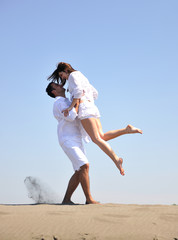 Wall Mural - happy young couple have fun on beach