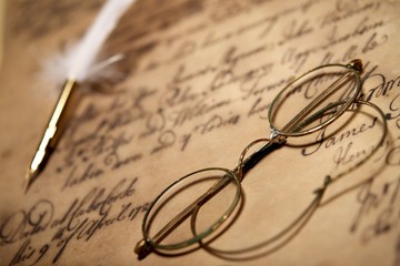 Wall Mural - Old glasses on vintage letter