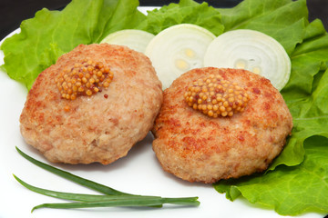 two cutlets with mustard