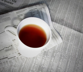 financial news and tea cup