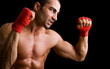 © cristovao31 - Young Boxer fighter over black background