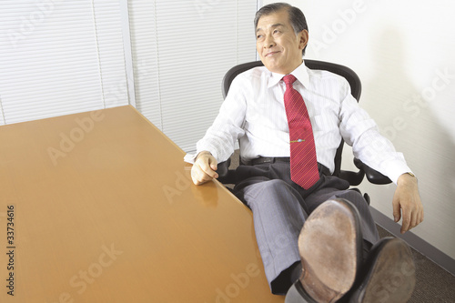 デスクに足を投げ出す社長 Stock Photo Adobe Stock