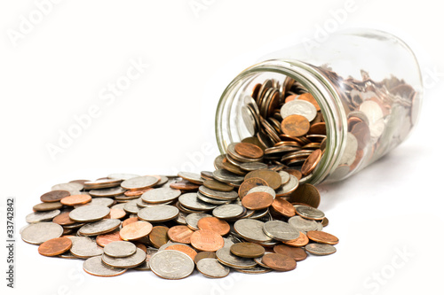 Fényképezés Jar Of US Coins Spilled On A White Background