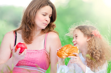 Poster - young mother and her daughter eating